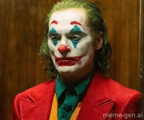 A Close Up Of A Man Dressed As The Joker In A Red Suit And Clown Makeup . GIF