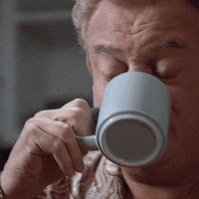 A Close Up Of A Man Drinking From A Mug GIF