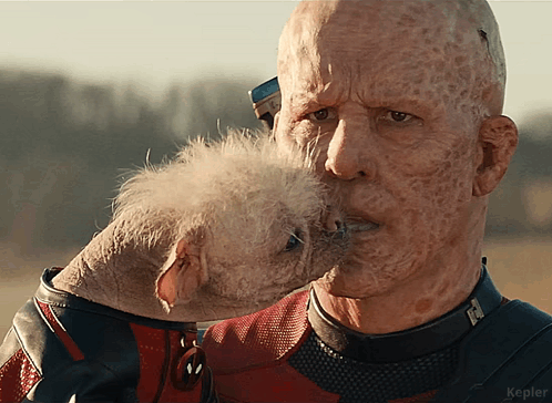 A Close Up Of A Man Holding A Small Dog With Kepler Written On The Bottom Right Corner GIF