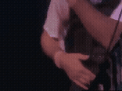 A Close Up Of A Man Holding A Woman 'S Leg In A Chair . GIF