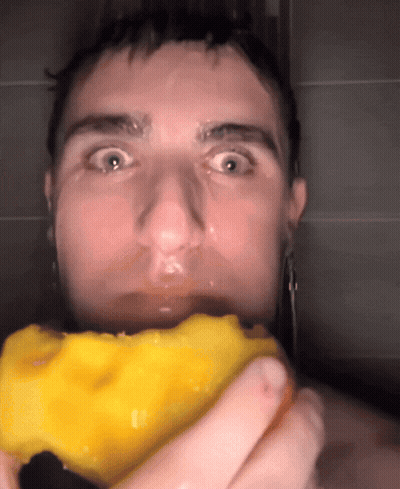 A Close Up Of A Man Holding A Yellow Object GIF