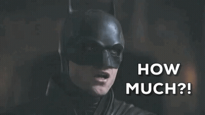 A Close Up Of A Man In A Batman Costume Saying How Much GIF