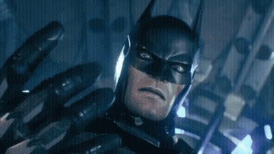A Close Up Of A Man In A Batman Costume With A Glove On His Hand . GIF