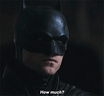 A Close Up Of A Man In A Batman Costume With The Words How Much Below Him GIF