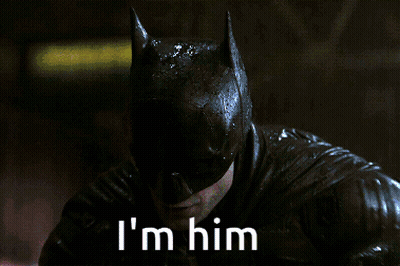 A Close Up Of A Man In A Batman Costume With The Words I 'M Him Below Him GIF