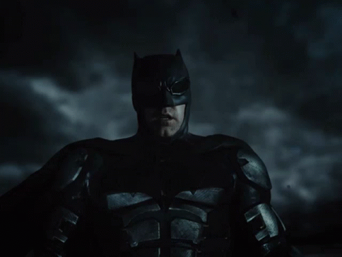 A Close Up Of A Man In A Batman Suit GIF