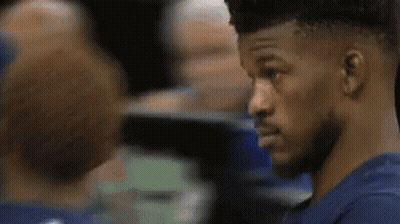 A Close Up Of A Man In A Blue Shirt Looking At Another Man . GIF