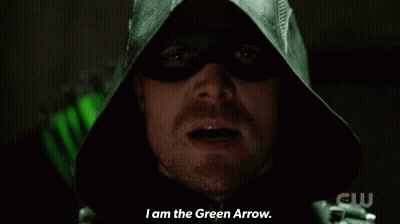 A Close Up Of A Man In A Green Hood Saying " I Am The Green Arrow " GIF