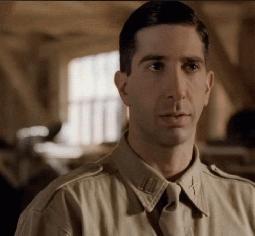 A Close Up Of A Man In A Military Uniform With A Cross On His Collar GIF