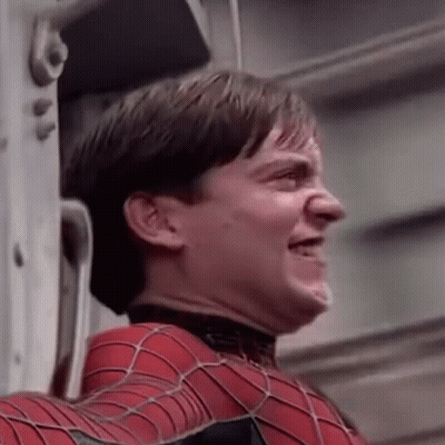 A Close Up Of A Man In A Spiderman Suit Making A Face . GIF