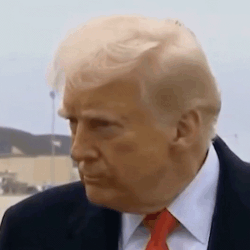 A Close Up Of A Man In A Suit And Tie . GIF
