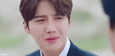 A Close Up Of A Man In A Suit And Tie Crying With His Eyes Closed . GIF