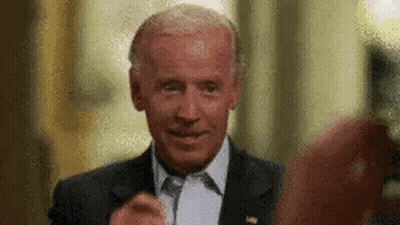 A Close Up Of A Man In A Suit And Tie Giving A Thumbs Up . GIF