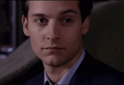 A Close Up Of A Man In A Suit And Tie Looking At The Camera GIF
