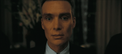 A Close Up Of A Man In A Suit And Tie Looking At The Camera GIF