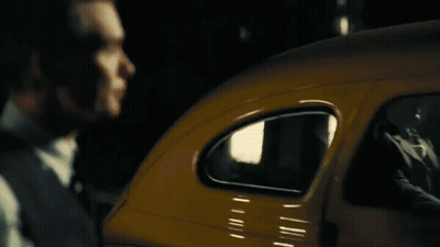 A Close Up Of A Man In A Suit And Tie Looking Down . GIF