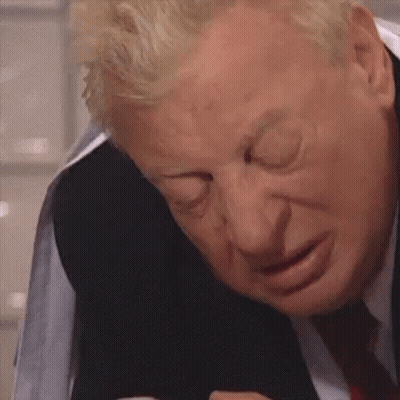 A Close Up Of A Man In A Suit And Tie Making A Face . GIF