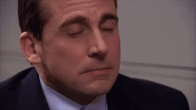 A Close Up Of A Man In A Suit And Tie Smiling GIF