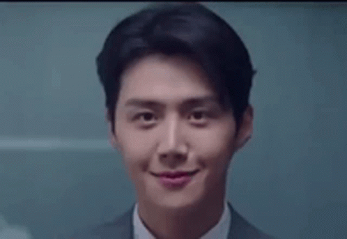 A Close Up Of A Man In A Suit And Tie Smiling At The Camera . GIF