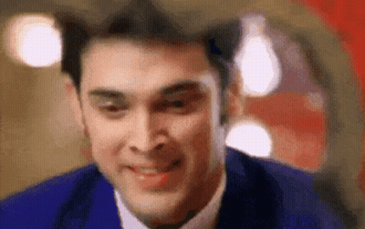 A Close Up Of A Man In A Suit And Tie Smiling . GIF