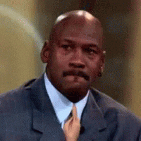 A Close Up Of A Man In A Suit And Tie With A Hand Holding His Tie . GIF