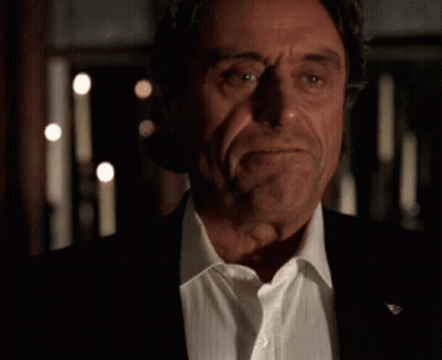A Close Up Of A Man In A Suit And White Shirt With His Eyes Closed . GIF
