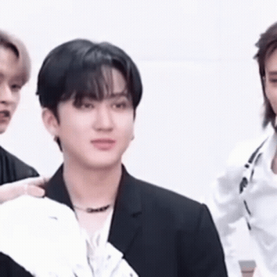 A Close Up Of A Man In A Suit Standing Next To Another Man . GIF