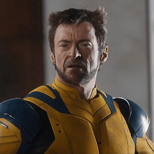 A Close Up Of A Man In A Yellow And Blue Suit GIF