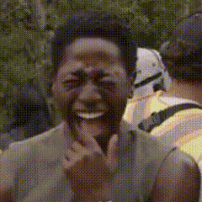 A Close Up Of A Man Laughing With A Stormtrooper In The Background GIF