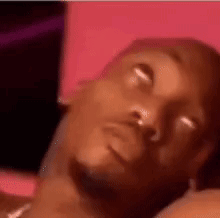 A Close Up Of A Man Laying Down With His Eyes Closed . GIF