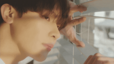 A Close Up Of A Man Looking Out A Window GIF