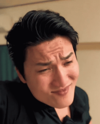 A Close Up Of A Man Making A Face With His Eyes Closed GIF