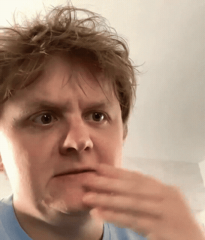A Close Up Of A Man Making A Face With His Hand GIF