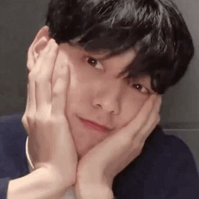 A Close Up Of A Man Making A Face With His Hands On His Face . GIF