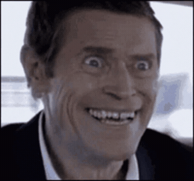 A Close Up Of A Man Making A Funny Face While Smiling . GIF