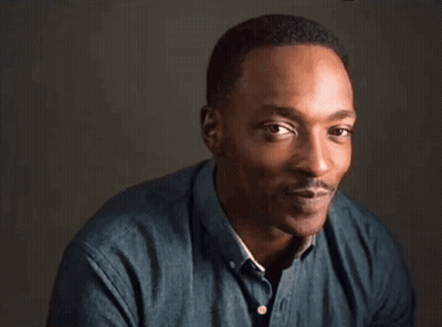 A Close Up Of A Man Making A Funny Face While Wearing A Blue Shirt . GIF