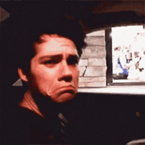 A Close Up Of A Man Making A Sad Face In A Car GIF
