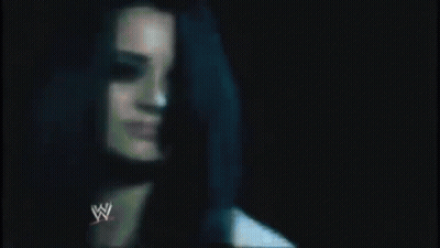 A Close Up Of A Man 'S Chest With A Wrestling Logo On It . GIF