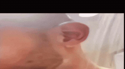 A Close Up Of A Man 'S Ear With A Blurred Background . GIF