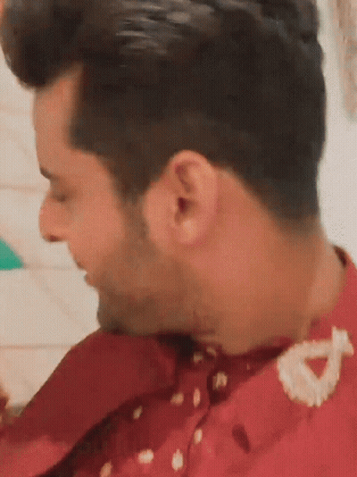 A Close Up Of A Man 'S Ear With A Red Shirt On . GIF