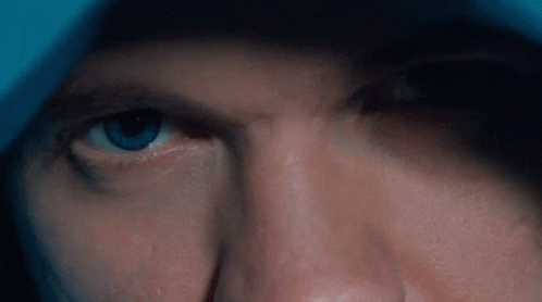A Close Up Of A Man 'S Eye With A Blue Iris GIF