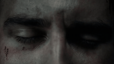 A Close Up Of A Man 'S Eye With Blood On His Forehead GIF