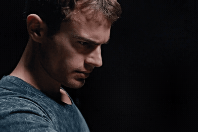 A Close Up Of A Man 'S Face Against A Black Background GIF