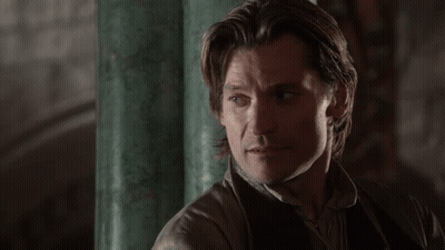 A Close Up Of A Man 'S Face Against A Green Wall GIF