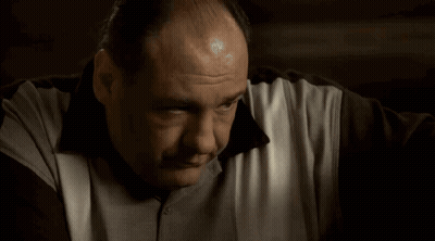 A Close Up Of A Man 'S Face And Arm With A Bandage On His Wrist . GIF