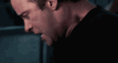 A Close Up Of A Man 'S Face And Neck In A Dark Room GIF