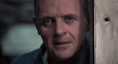 A Close Up Of A Man 'S Face Behind A Wall GIF