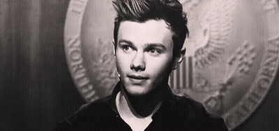 A Close Up Of A Man 'S Face In A Black And White Photo With A Coin In The Background . GIF
