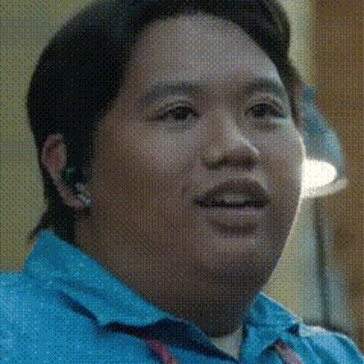 A Close Up Of A Man 'S Face In A Blue Shirt GIF