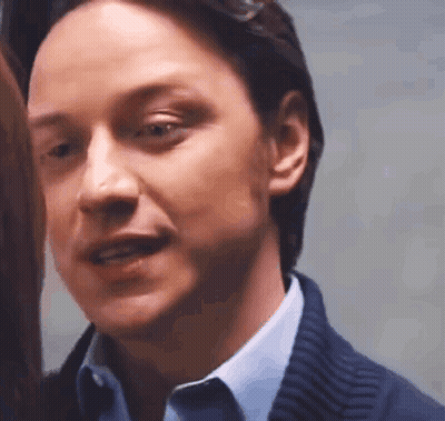 A Close Up Of A Man 'S Face In A Blue Shirt And Blue Sweater . GIF